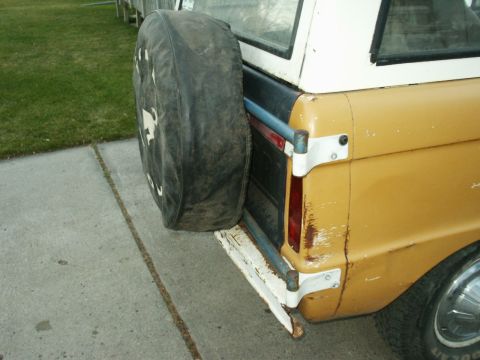 1966 Ford Bronco - The rear view of a 1966 Ford Bronco shows its distinctive spare tire carrier and two-tone paint scheme.