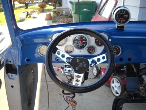 1954 Ford F-100 - Interior view of a classic truck dashboard with custom gauges and steering wheel.