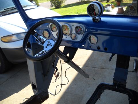 1954 Ford F-100 - The interior of a 1954 Ford F-100 pickup truck, a custom dashboard with multiple gauges and a modern steering wheel.