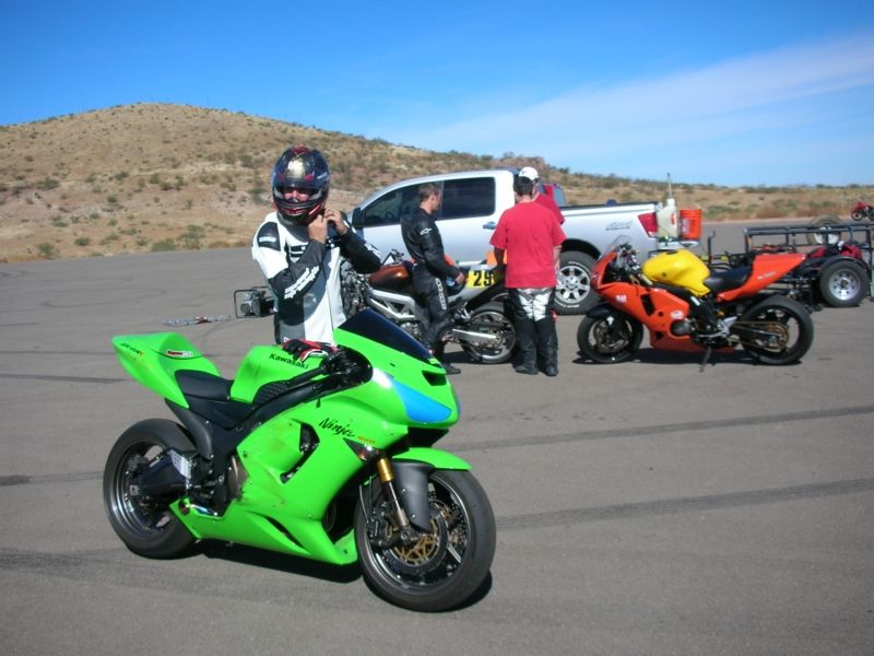 Green Kawasaki Ninja motorcycle with blue accents on front fairing