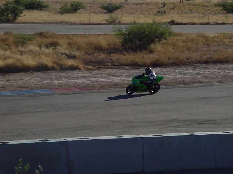 Green motorcycle on a race track, side view
