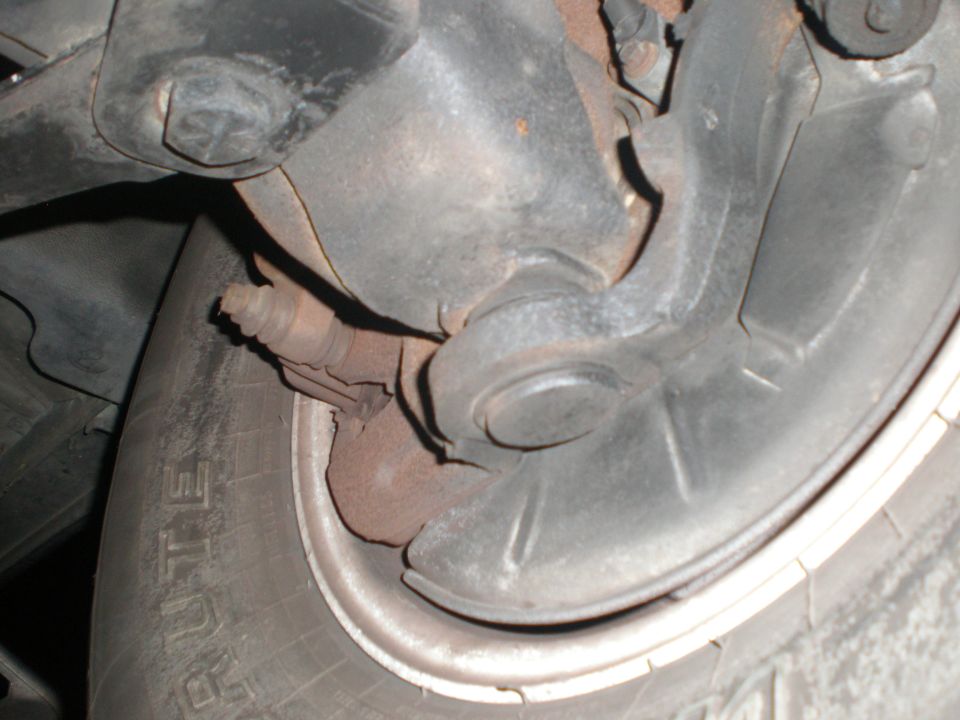 Underbody view of a vehicle ball joint, steering knuckle and tire labeled BRUTE