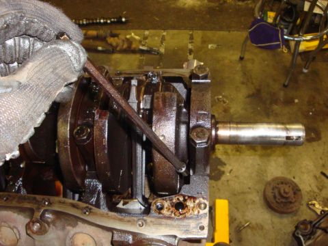1989 Ford Bronco - Close-up of an engine's crankshaft and connecting rods during a repair or rebuild.