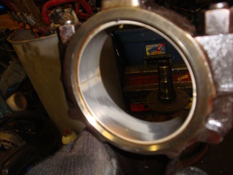 1989 Ford Bronco - Metal bearing housing with a shaft visible through the opening, likely a vehicle part.