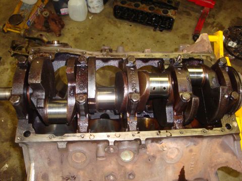 1989 Ford Bronco - Close-up view of an engine's crankshaft and main bearing caps.