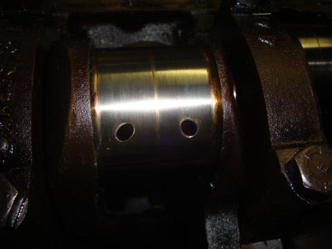 1989 Ford Bronco - Close-up of an engine crankshaft bearing, showing wear and oil passages.