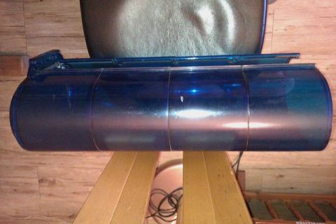 1991 Ford Crown Victoria - A blue cylindrical tank is shown mounted on a wooden stand, likely a component for a vehicle.