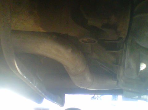 1994 Ford F-150 - The underside of a vehicle is visible, focusing on the exhaust system and frame structure.