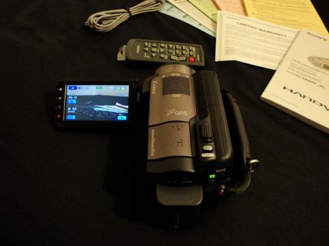 1993 Ford Taurus - Sony Handycam camcorder and its accessories are laid out on a dark surface.