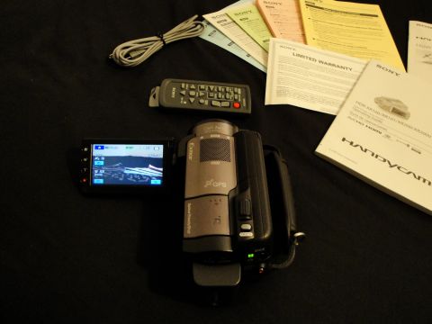 1993 Ford Taurus - A Sony Handycam camcorder and its accessories are displayed on a dark background, including manuals and a remote control.