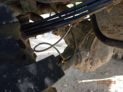 1989 Ford Bronco - Undercarriage view showing the rear axle assembly and suspension components.