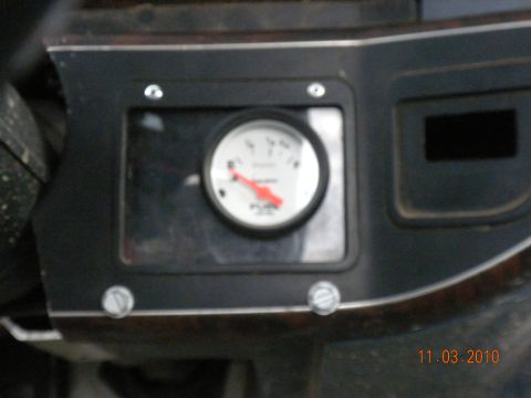1989 Ford Bronco - A close-up view of a fuel gauge with a red needle pointing towards empty.