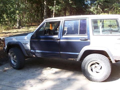 1992 Jeep Cherokee - Side view of a 1992 Jeep Cherokee with custom paint and wheels.