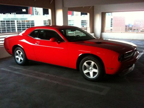 2010 Dodge Challenger - A red Dodge Challenger is parked in a multi-level parking garage.