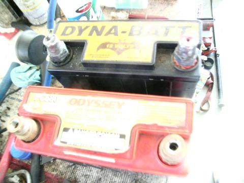 1995 Ford Probe - A black Dyna-Batt 12-volt battery is shown next to a red Odyssey battery.