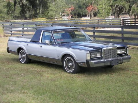 1972 Ford Ranchero - This two-tone pickup truck, likely from the early 1980s, features a distinctive vinyl roof and a unique utility bed.