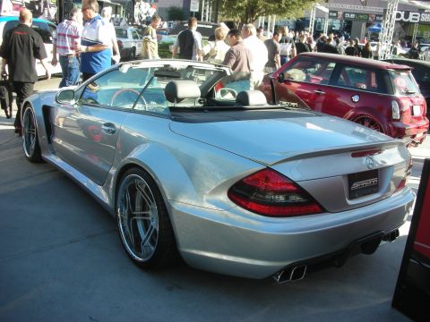 1998 Ford Crown Victoria - Silver convertible sports car with custom wheels and body kit at an outdoor event.