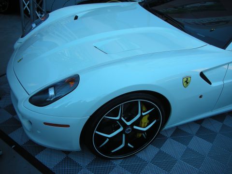 1998 Ford Crown Victoria - A white sports car is viewed from the front quarter, revealing its distinctive wheel and Ferrari emblem.