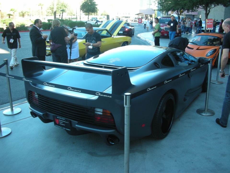 Dark grey sports car with 'Cheyenne' text on the side and a large rear wing