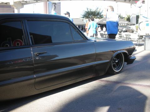 1998 Ford Crown Victoria - glossy black lowered classic two-door coupe shown in side profile at an outdoor event.