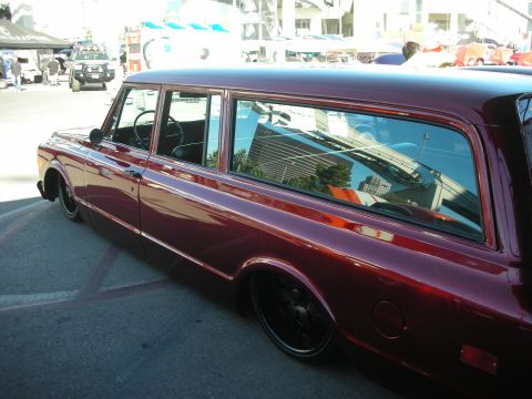 1998 Ford Crown Victoria - deep-red lowered two-door classic station wagon shown in side profile at an outdoor show.