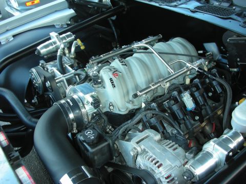 1998 Ford Crown Victoria - LS-style V8 swapped into a custom engine bay, showing the intake manifold, fuel rails and alternator.