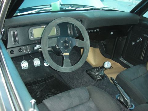 1998 Ford Crown Victoria - stripped race interior featuring a suede Sparco steering wheel, drilled alloy pedals and floor shifter.