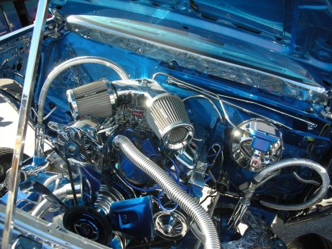 1998 Ford Crown Victoria - Detailed view of a show car's chromed engine with engraved blue firewall, chrome air cleaner and braided lines.