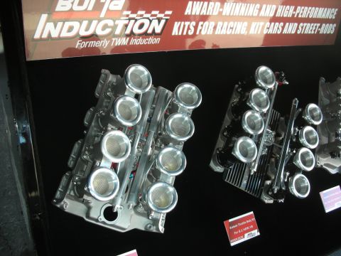 1998 Ford Crown Victoria - Polished individual-throttle-body intake systems displayed under a Borla Induction banner.
