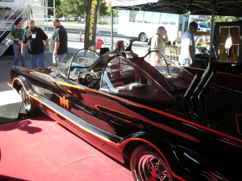 1998 Ford Crown Victoria - 1960s-style Batmobile replica in black with red trim, a bat emblem and dual bubble canopies on display.