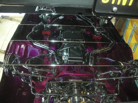 1998 Ford Crown Victoria - show-car underside detail featuring extensive chrome plating, polished components and metallic purple paint on the chassis.