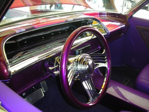1998 Ford Crown Victoria - Interior of a customized classic car showing a polished billet steering wheel, chromed dash trim and metallic purple paint.