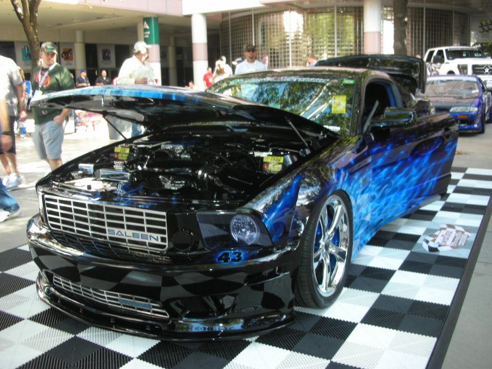 Black and blue flame Saleen Mustang on checkered display floor