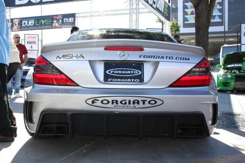 1998 Ford Crown Victoria - Rear view of a silver widebody Mercedes-Benz SL displaying Forgiato Wheels and Misha lettering with a wide diffuser.