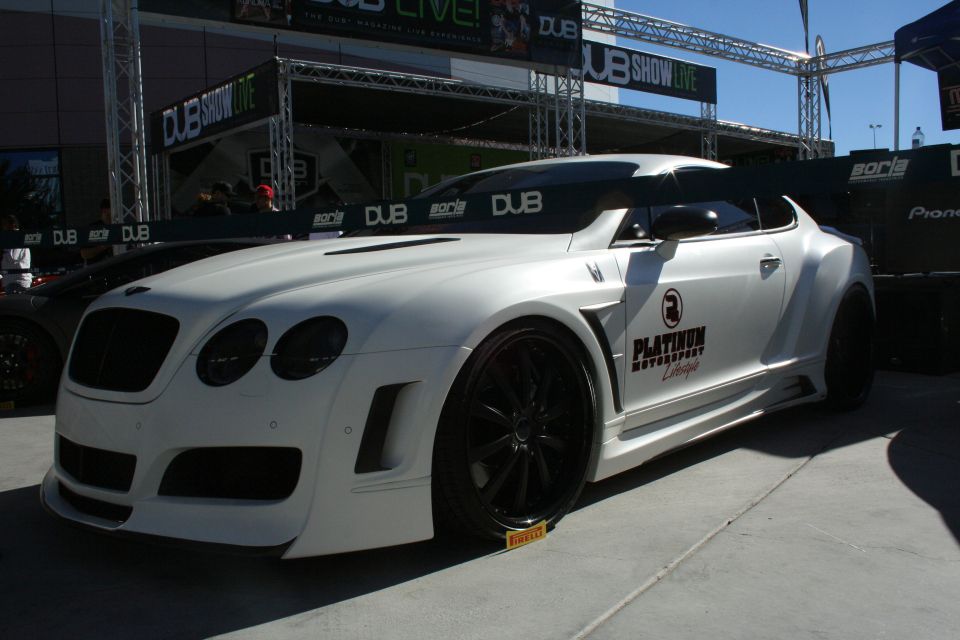 White widebody coupe with black wheels and 'Platinum Motorsport' decal on the door