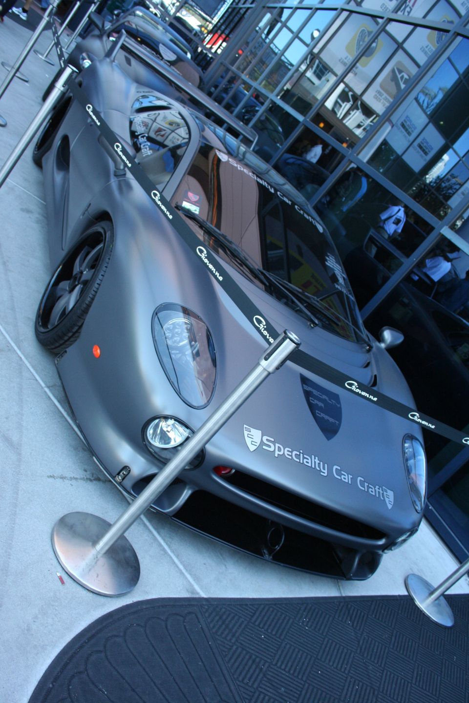 Matte gray supercar shot from above showing roof, windshield and Specialty Car Craft decal