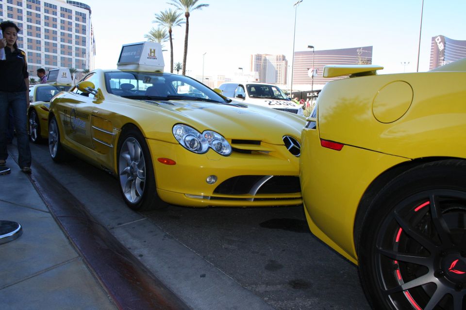 Front three-quarter of a yellow Mercedes-Benz SLR McLaren beside another yellow car