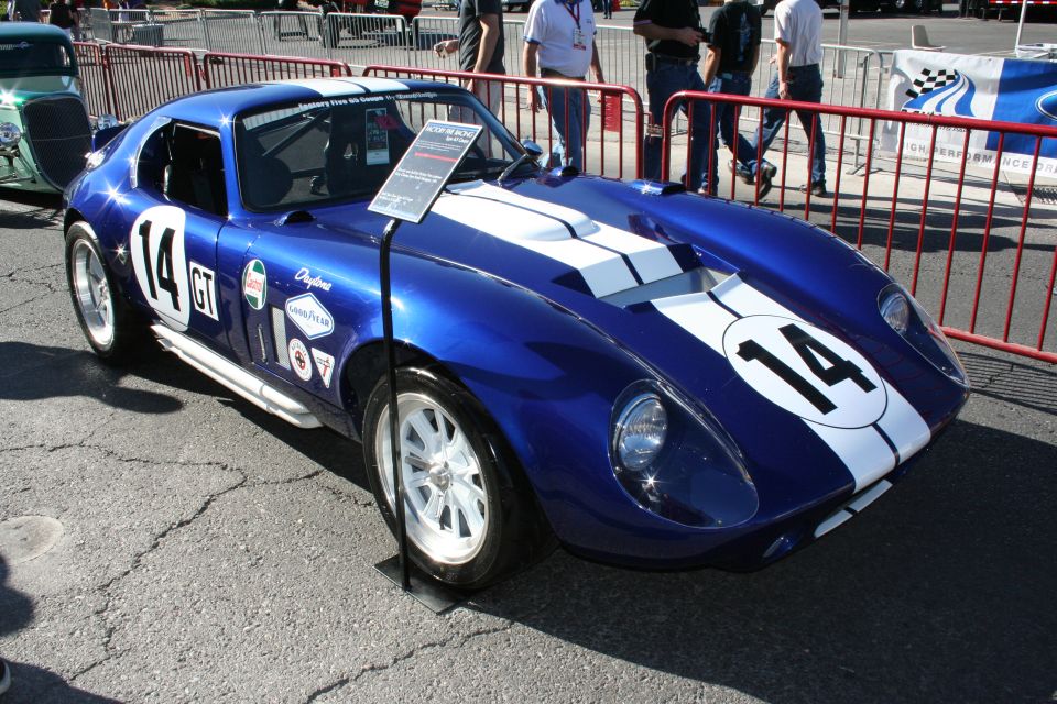 Blue Shelby Cobra Daytona-style coupe number 14 with white racing stripes