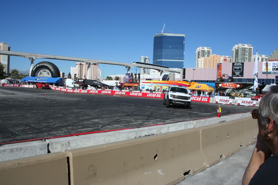 White pickup truck on an outdoor demo course ringed by Lucas Oil banners