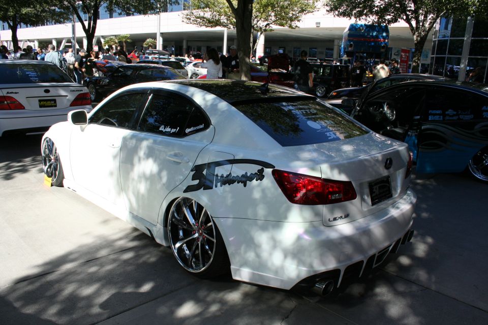 White Lexus IS coupe lowered on chrome wheels at car show