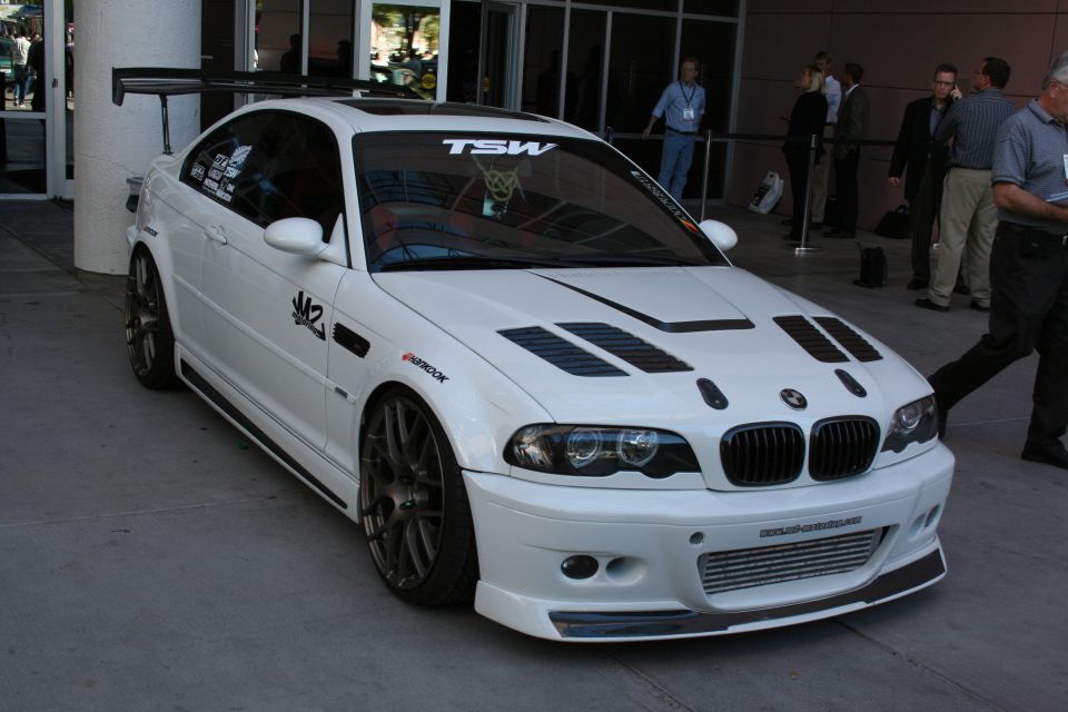 White BMW M3 with vented hood, splitter and rear wing at show