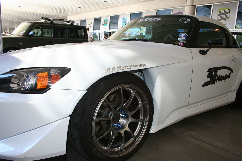 White Honda S2000 convertible with JLB Motorsports decals and bronze wheels