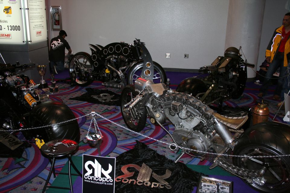 Row of custom chopper motorcycles on display with RK Concepts signs