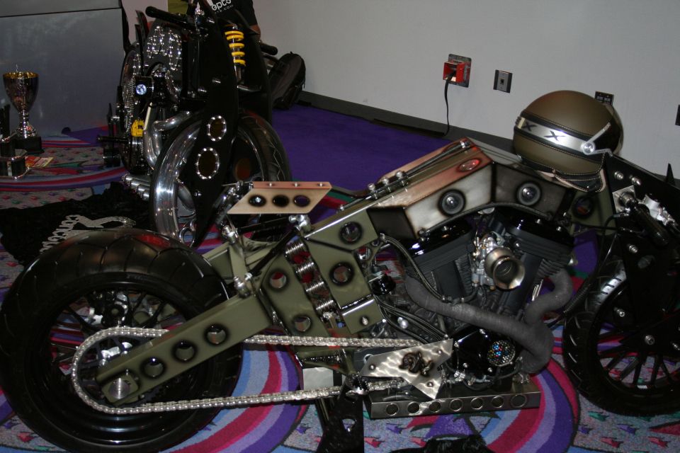Olive-green custom chopper motorcycle frame with V-twin engine