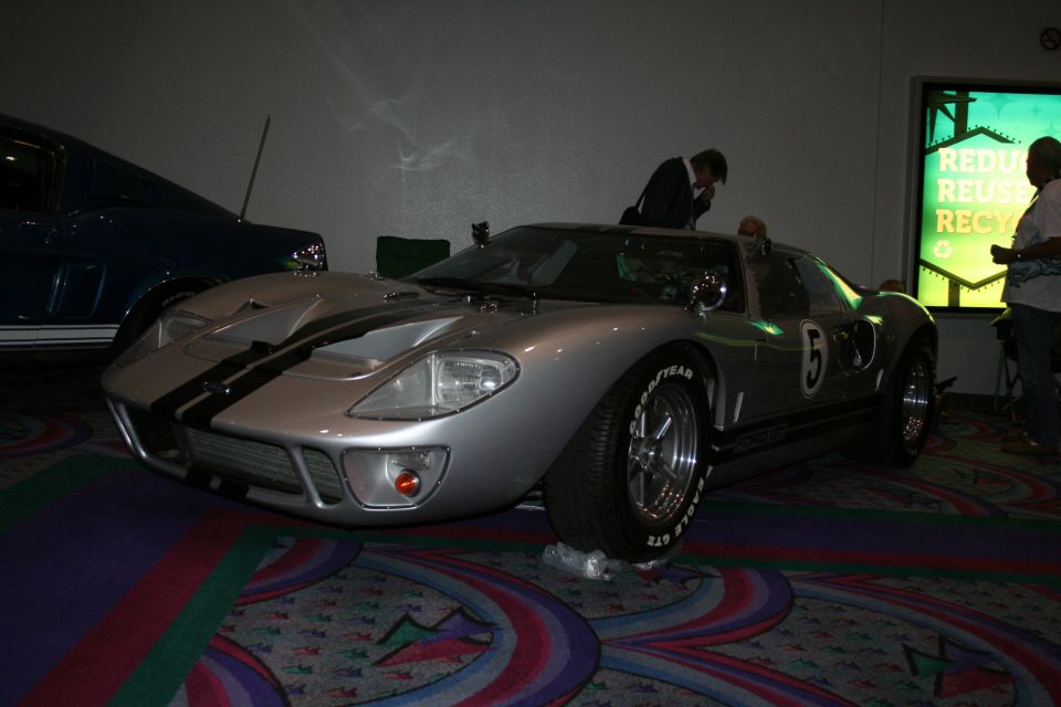 Silver GT40-style race car with blue stripes and number 5 at indoor show