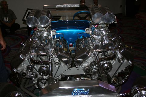 1998 Ford Crown Victoria - Front view of a blue hot rod showing two highly polished chromed supercharged V8 engines side by side with a Ford-marked oil pan.