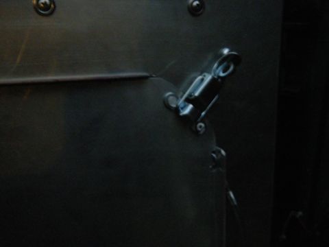 1981 Ford E350 - Close-up of a dark interior panel a metal latch mechanism and visible rivets.