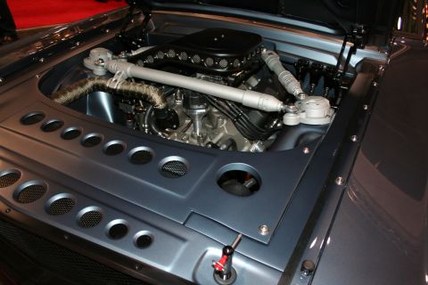 1998 Ford Crown Victoria - Engine bay of a custom car displaying a polished V8 with chrome air cleaner and a perforated metal cover panel.