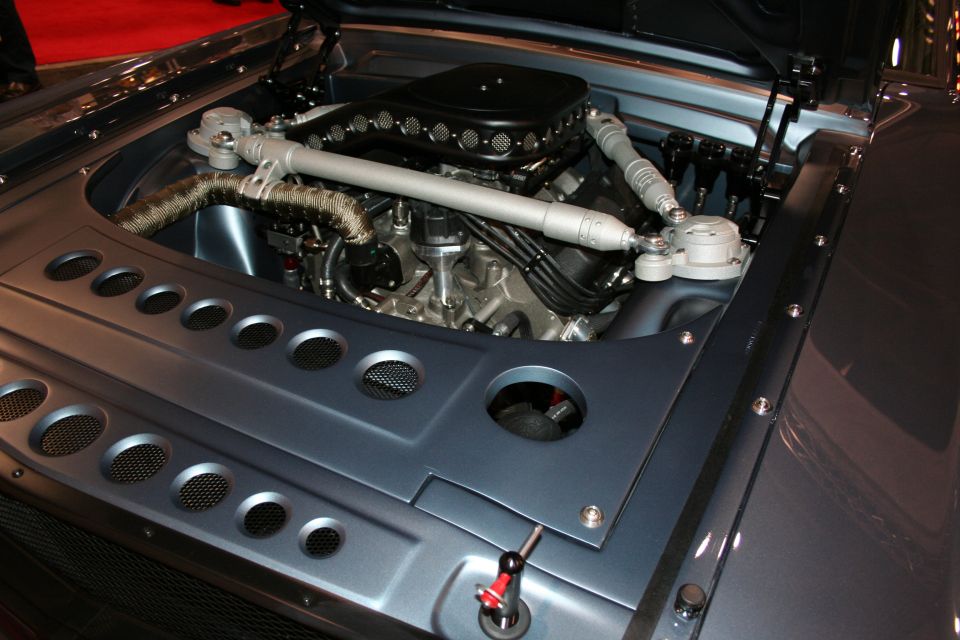 Polished V8 engine in a gray custom car engine bay