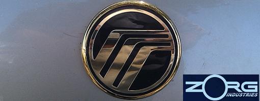Mercury emblem on a silver surface, with Zorg Industries logo in the lower right corner